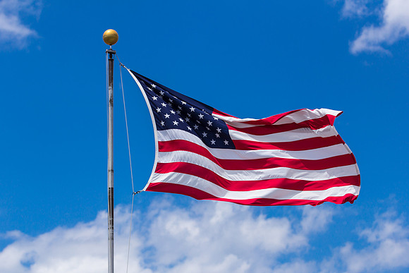 American Flag with Clouds and Blue Sky