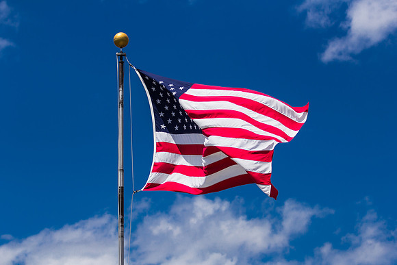 American Flag Close-up Against Blue Sky