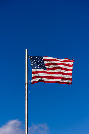 American Flag in high wind on clear day