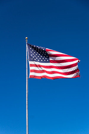 American Flag Against Blue Sky Vertical